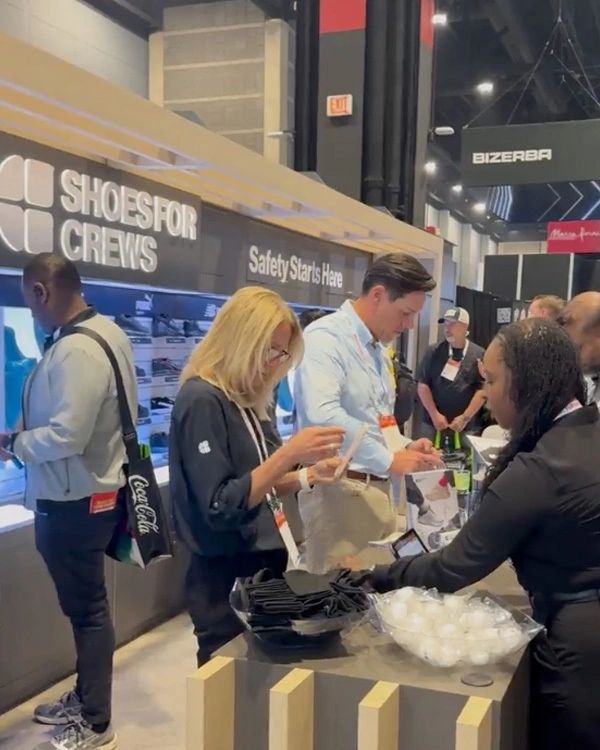 people standing around shoes for crews trade show booth