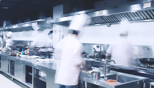 Chefs cooking inside a restaurant kitchen